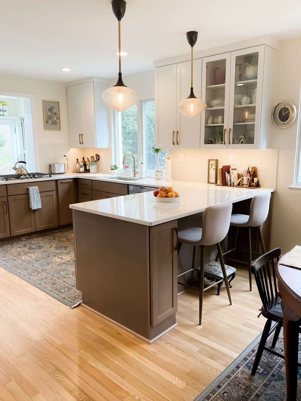 Kitchen Counter Seating With White Cabinets and Wood Flooring