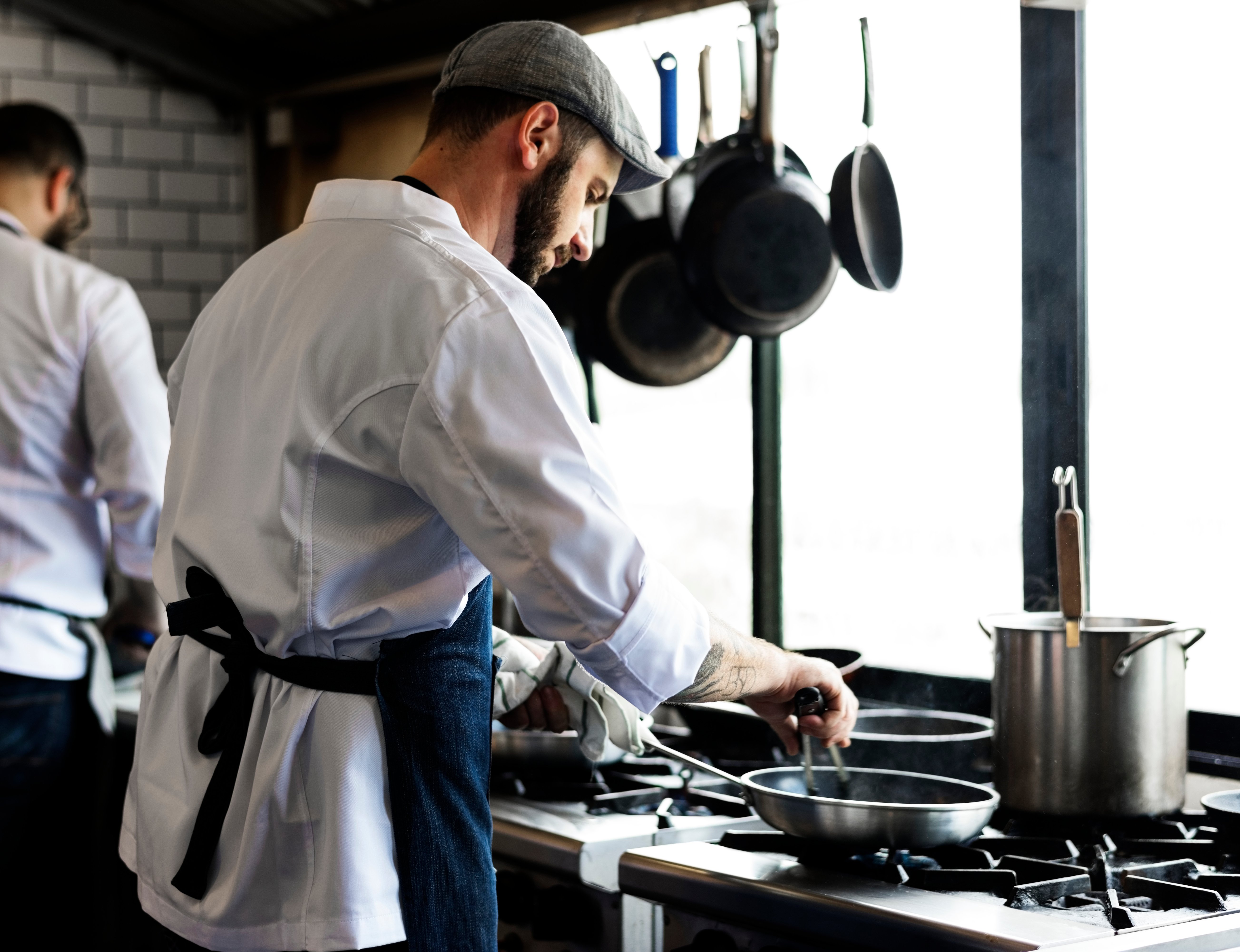 Chef cooking in a restaurant kitchen.