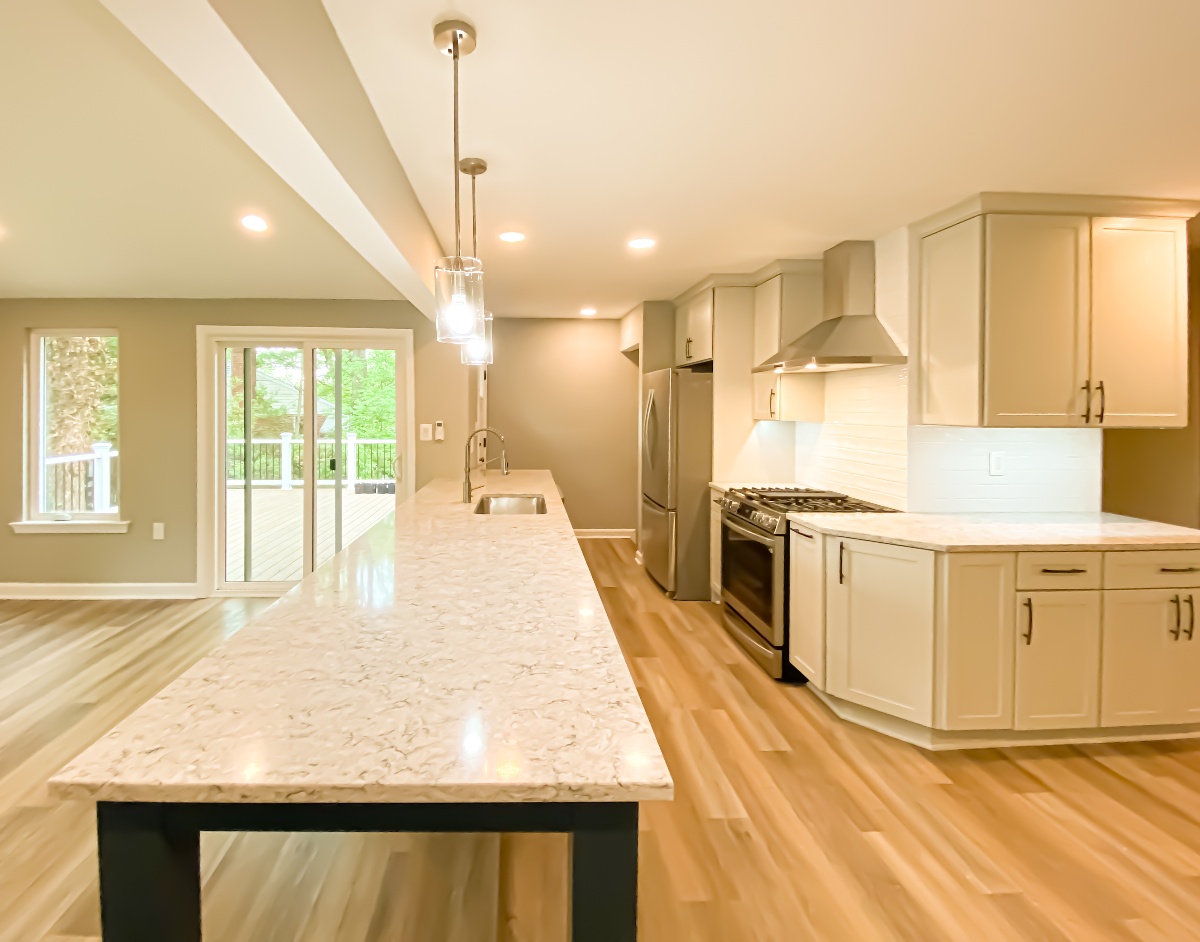Beautiful kitchen with butlers pantry and a very long kitchen island with a built in sink and basin