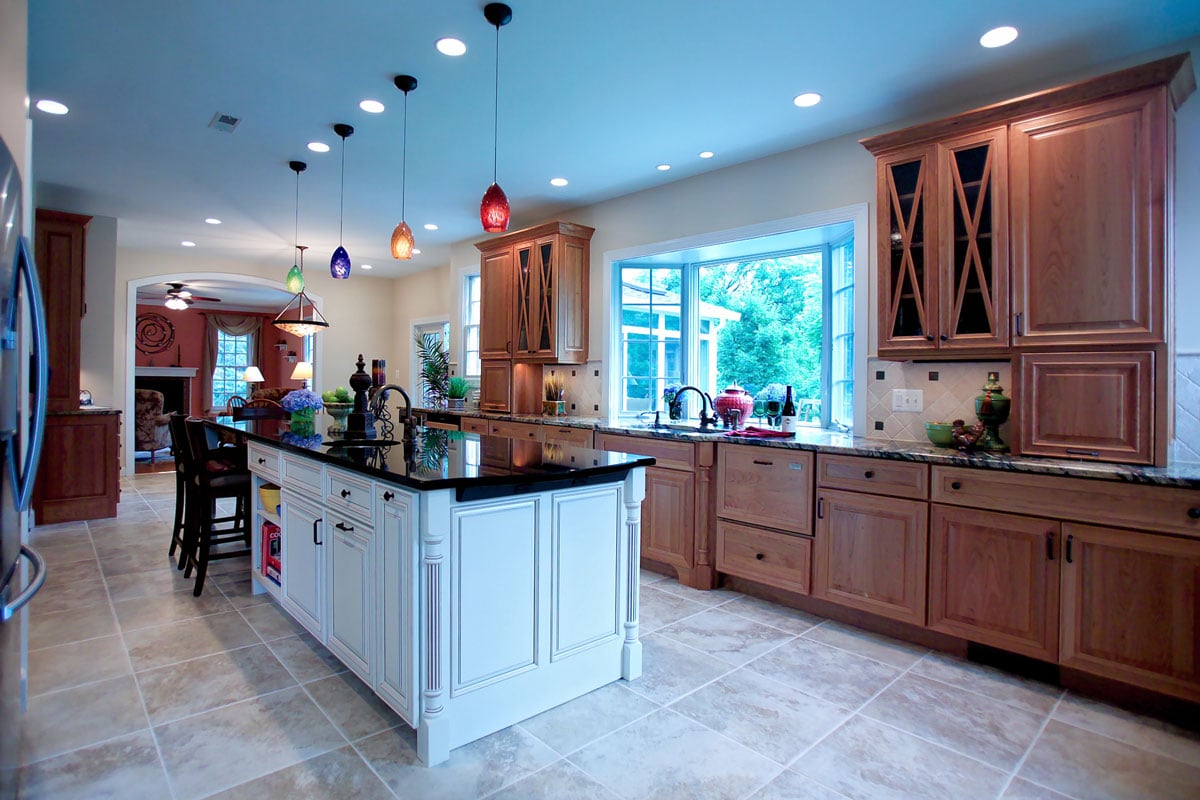 Kitchen remodel with wooden natural cabinetry and white island
