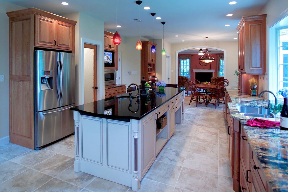 Natural wooden cabinetry and butlers pantry with stainless steel fridge