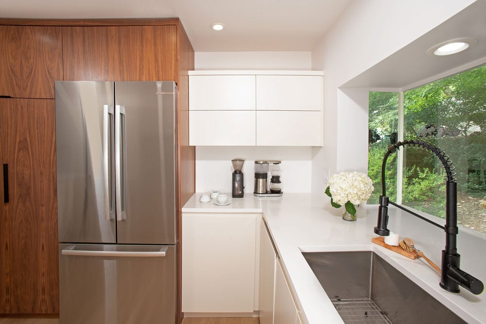 White bouquet of flowers on a pure white kitchen countertop