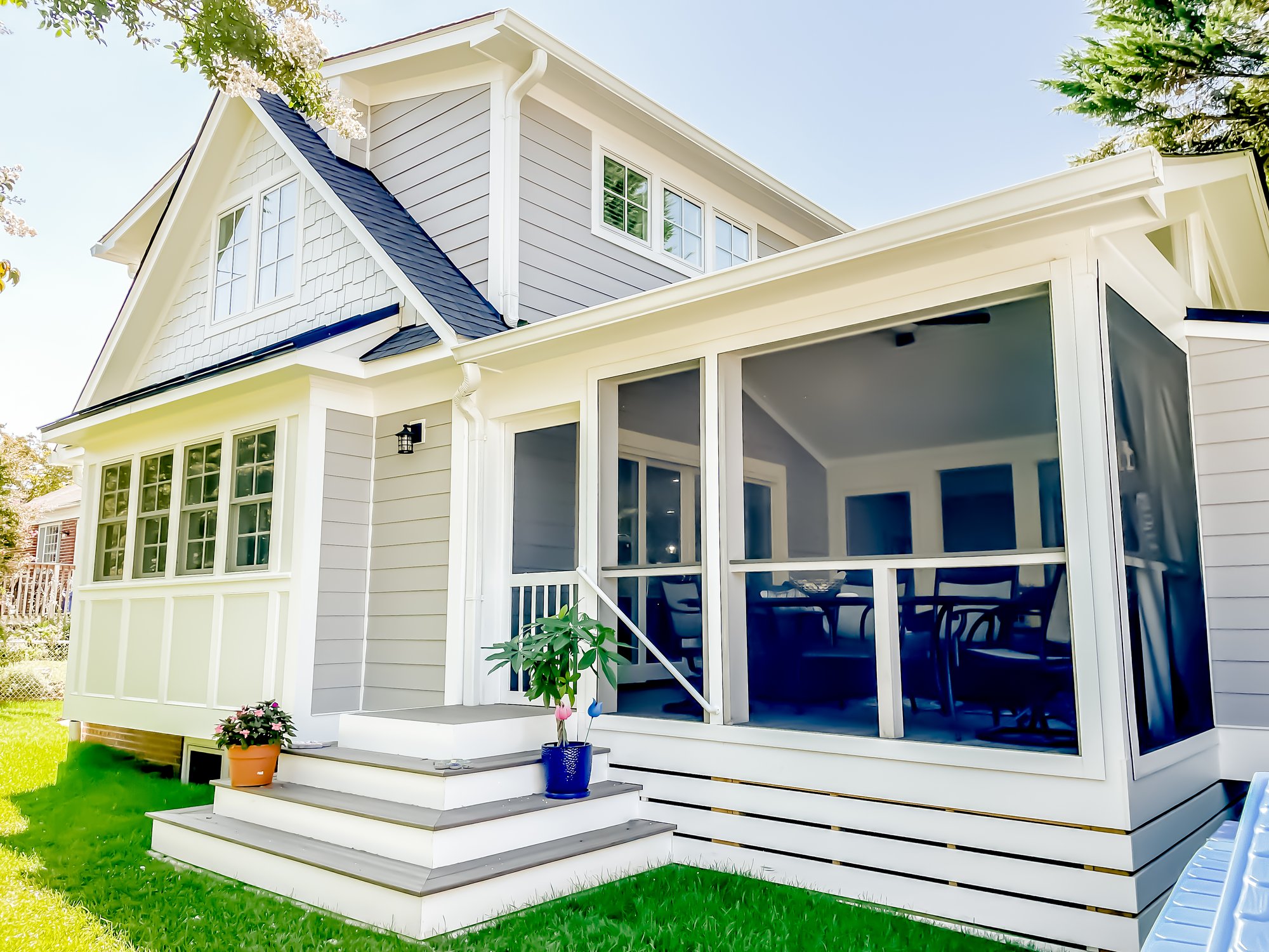 Outside of a home with a screened in porch.