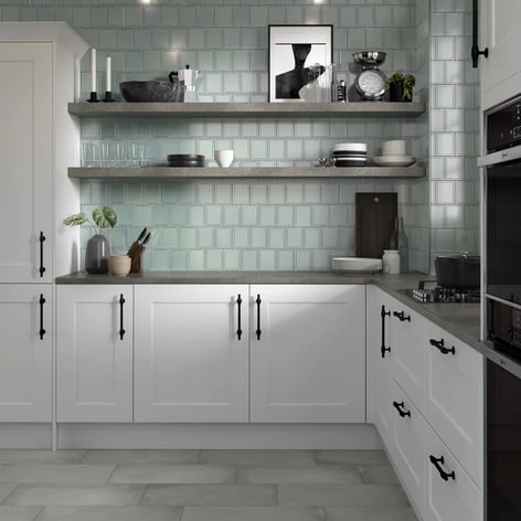 Kitchen with backsplash of textured tile.