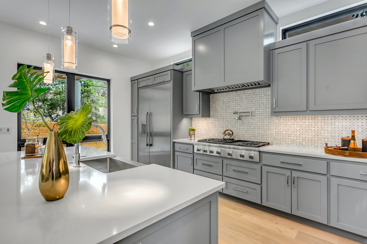 Kitchen remodel with grey storage options and hardwood floor