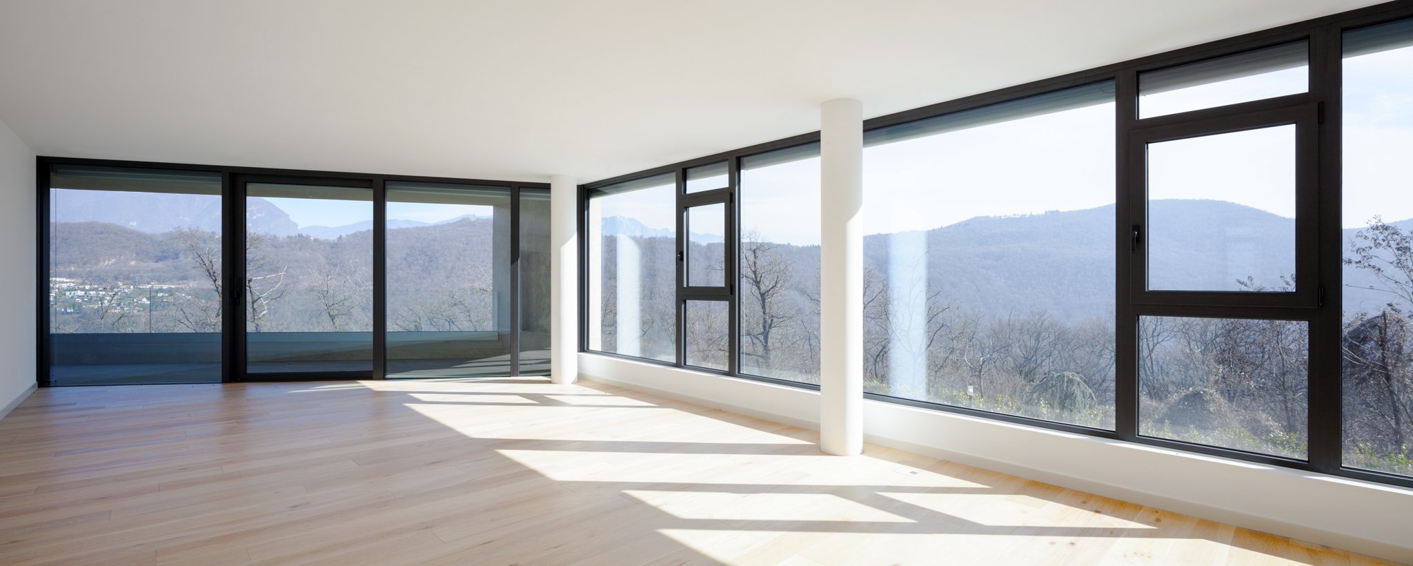 A bright room with windows facing the outside in all direction.