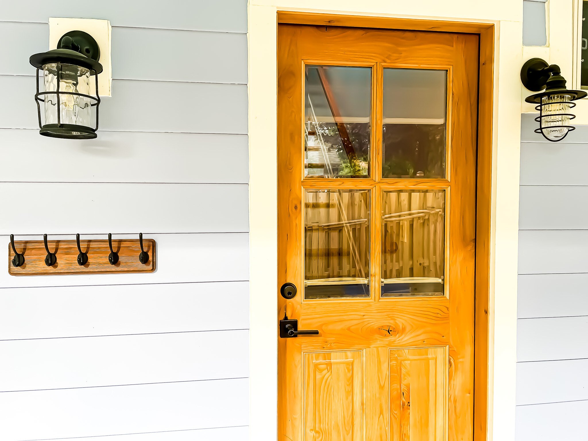 photo of the exterior front entrance of a home that has a stained wood door